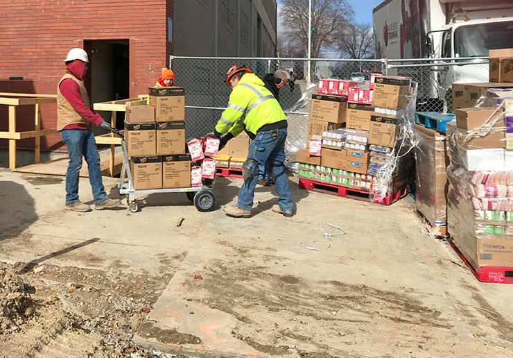 Graham Construction crew helps unload delivery to MCSA