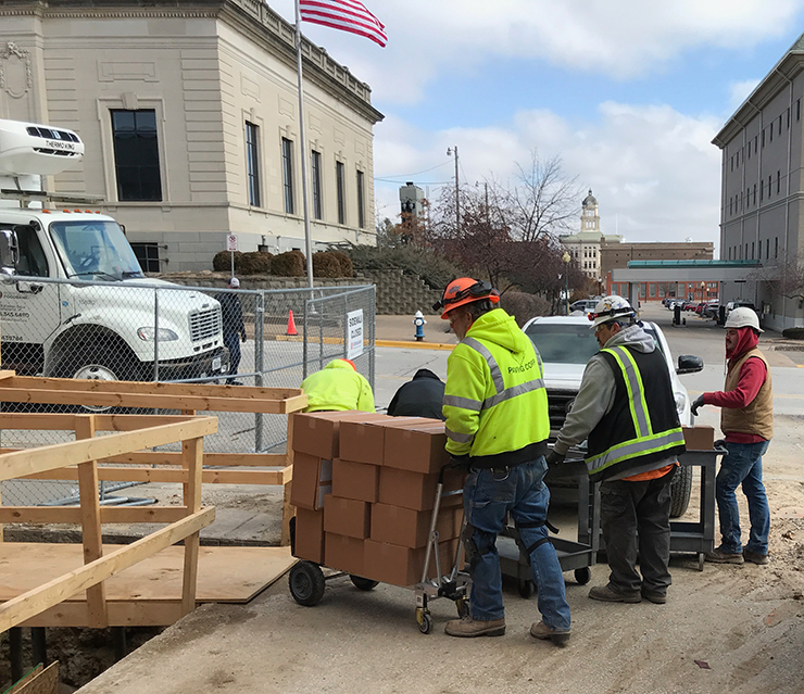 Graham Construction crew helps unload delivery to MCSA