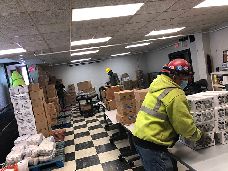 Graham Construction crew helps unload delivery to MCSA